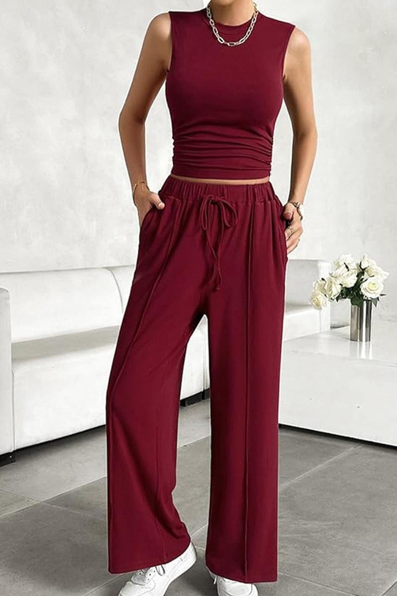 Woman wearing burgundy Stroll & Hangout Ribbed Knit sleeveless top and wide-leg pants two-piece set with casual white sneakers.