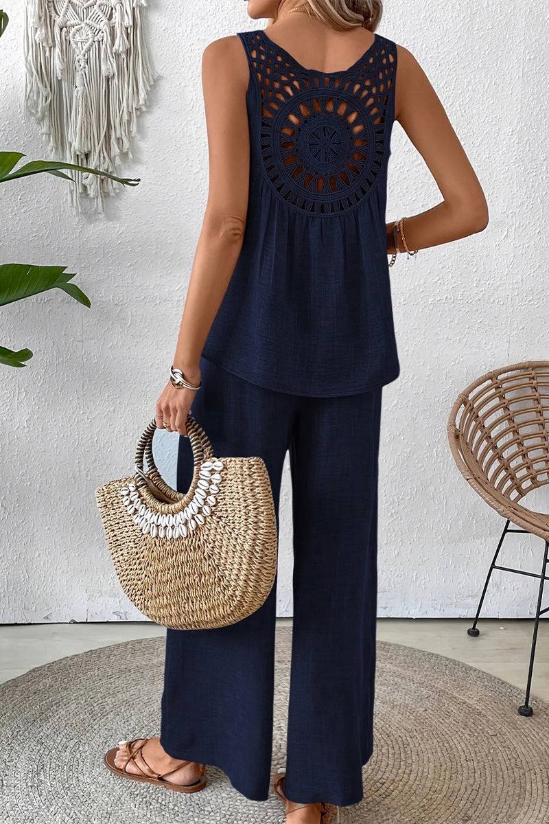 Woman wearing Dreamcatcher Crochet-Back navy two-piece set with crochet mandala back and wide-leg palazzo pants.