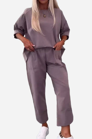 Women's comfortable and stylish grey two-piece set with crew neck sweatshirt and jogger pants with pockets