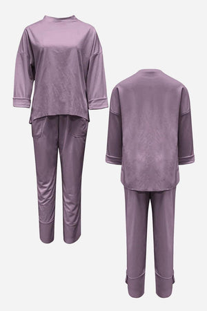 Purple two-piece set with crew neck sweatshirt and jogger pants, wrinkle-resistant polyester for casual comfort and style.