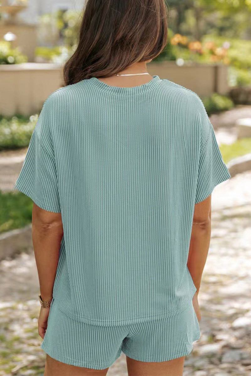 Back view of woman wearing light blue textured relaxed fit top and matching shorts set for slow mornings and casual wear outdoors