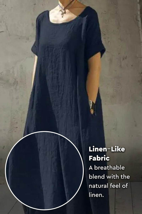 Breeze Cocoon Dress in navy with rolled sleeves, deep side pockets, and linen-like breathable fabric.