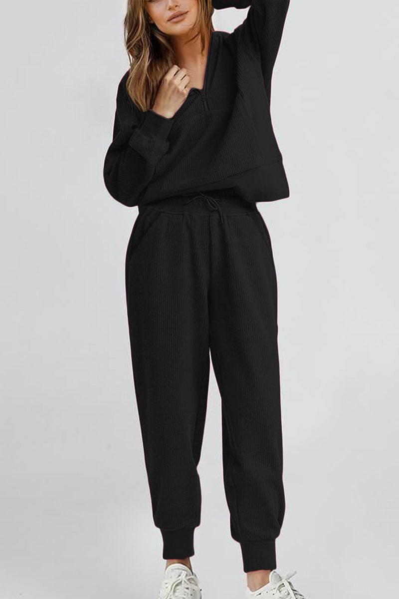 Unisex half-zip pullover and sweatpants set in black with relaxed fit and stand collar design