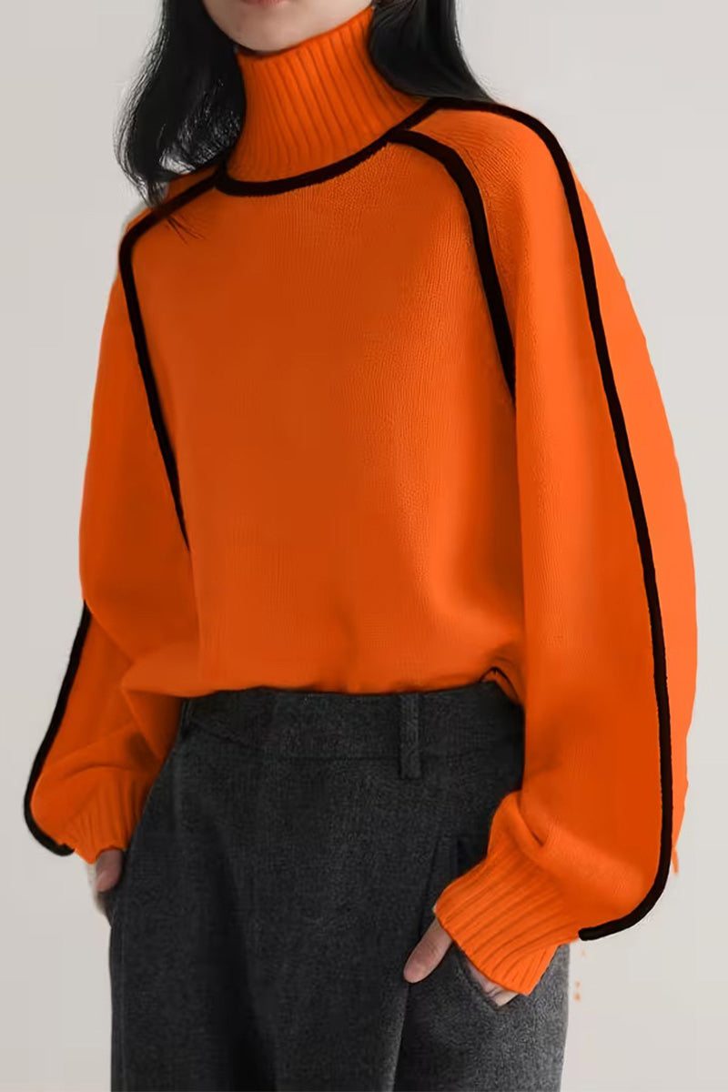 Orange Zero Itch Turtleneck Sweater with black slimming contrast trim and relaxed fit worn with grey trousers