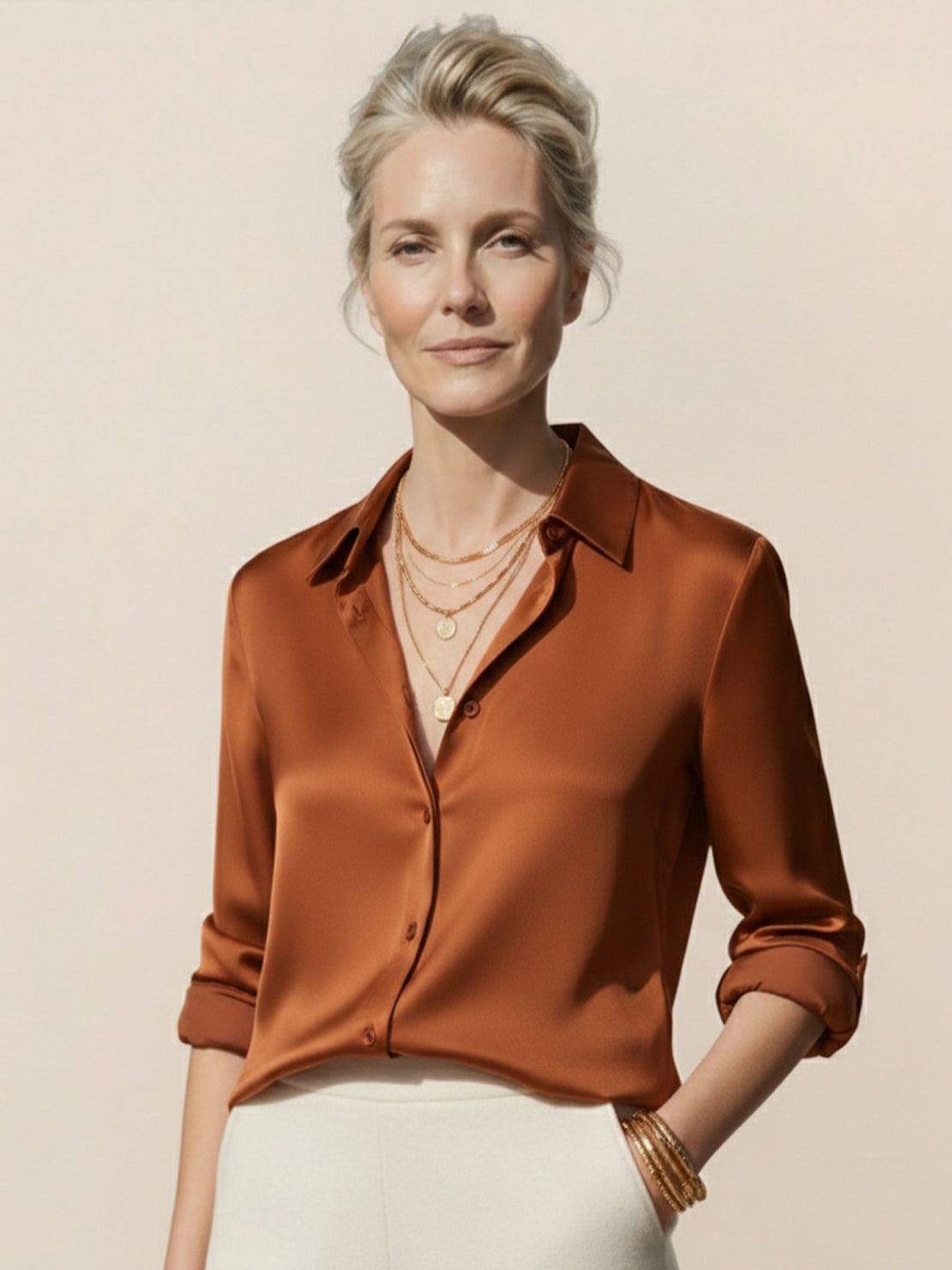 Woman wearing a smooth silk-finish button front shirt with relaxed fit and curved hem