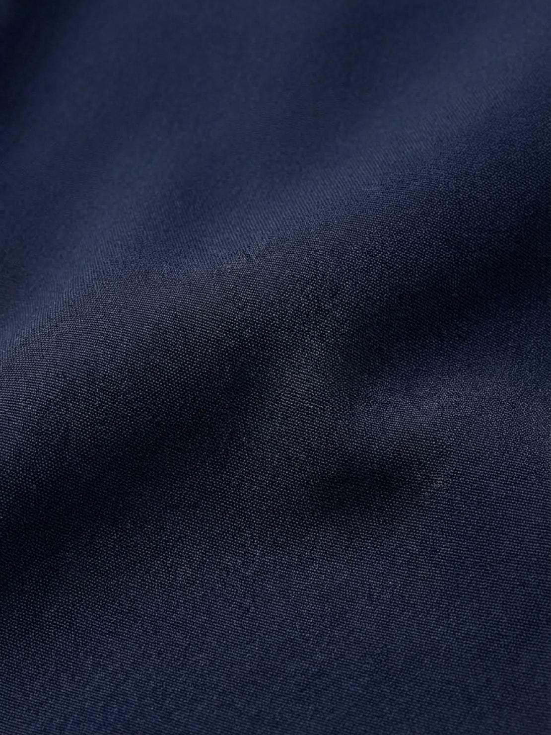 Long wrinkle-free button-down maxi dress with point collar, chest pockets, side slits, and roll-up sleeves