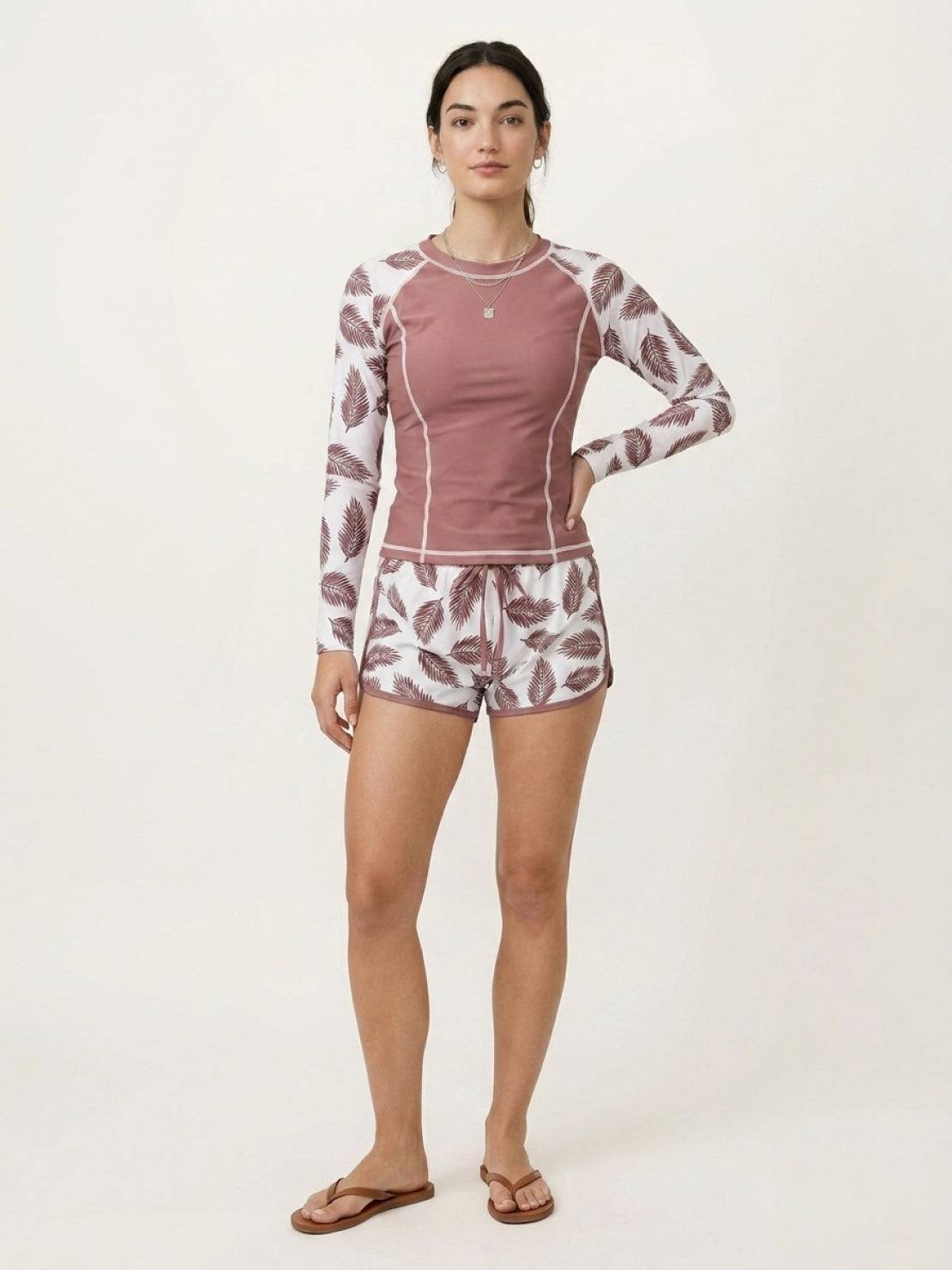 Long-sleeve UV rash guard set with tropical print sleeves and matching swim shorts for sun protection and water activities