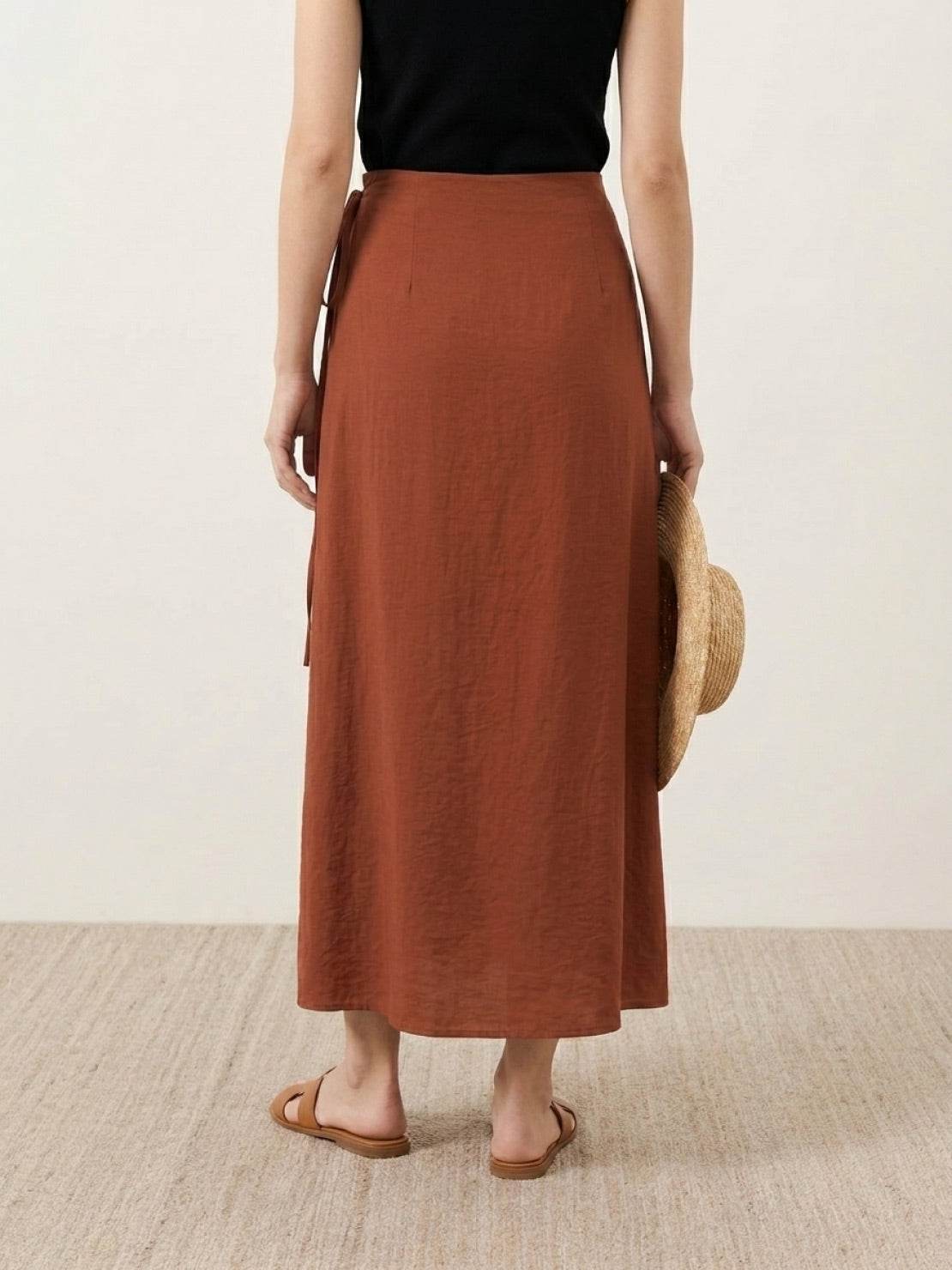 Asymmetrical wrap maxi skirt with side tie and flowy fabric in vibrant magenta color