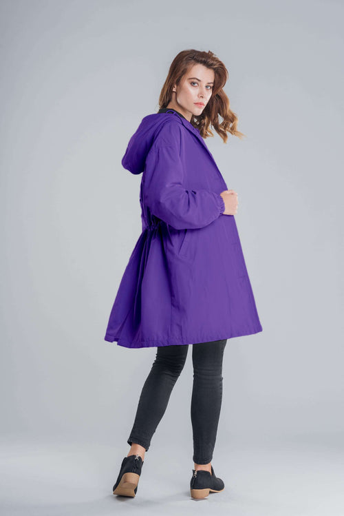 purple water resistant oversized hooded windbreaker jacket worn by woman