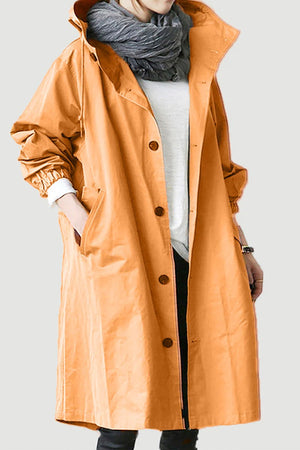 Water Resistant Oversized Windbreaker in orange with hood and button closure worn over casual outfit