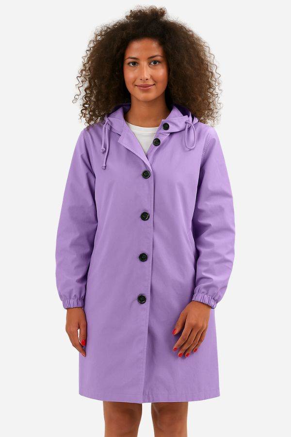 Woman wearing a purple water-resistant oversized hooded windbreaker rain jacket