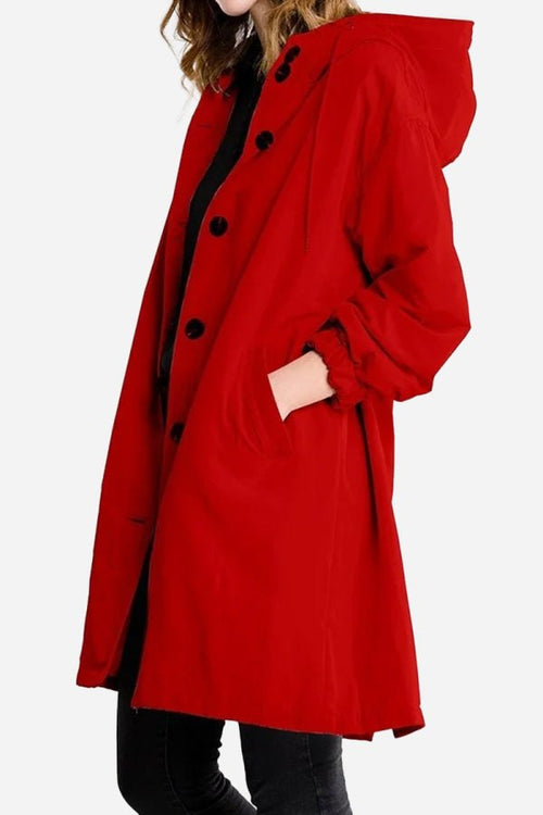 Red water-resistant oversized hooded windbreaker rain jacket with button closure and pockets