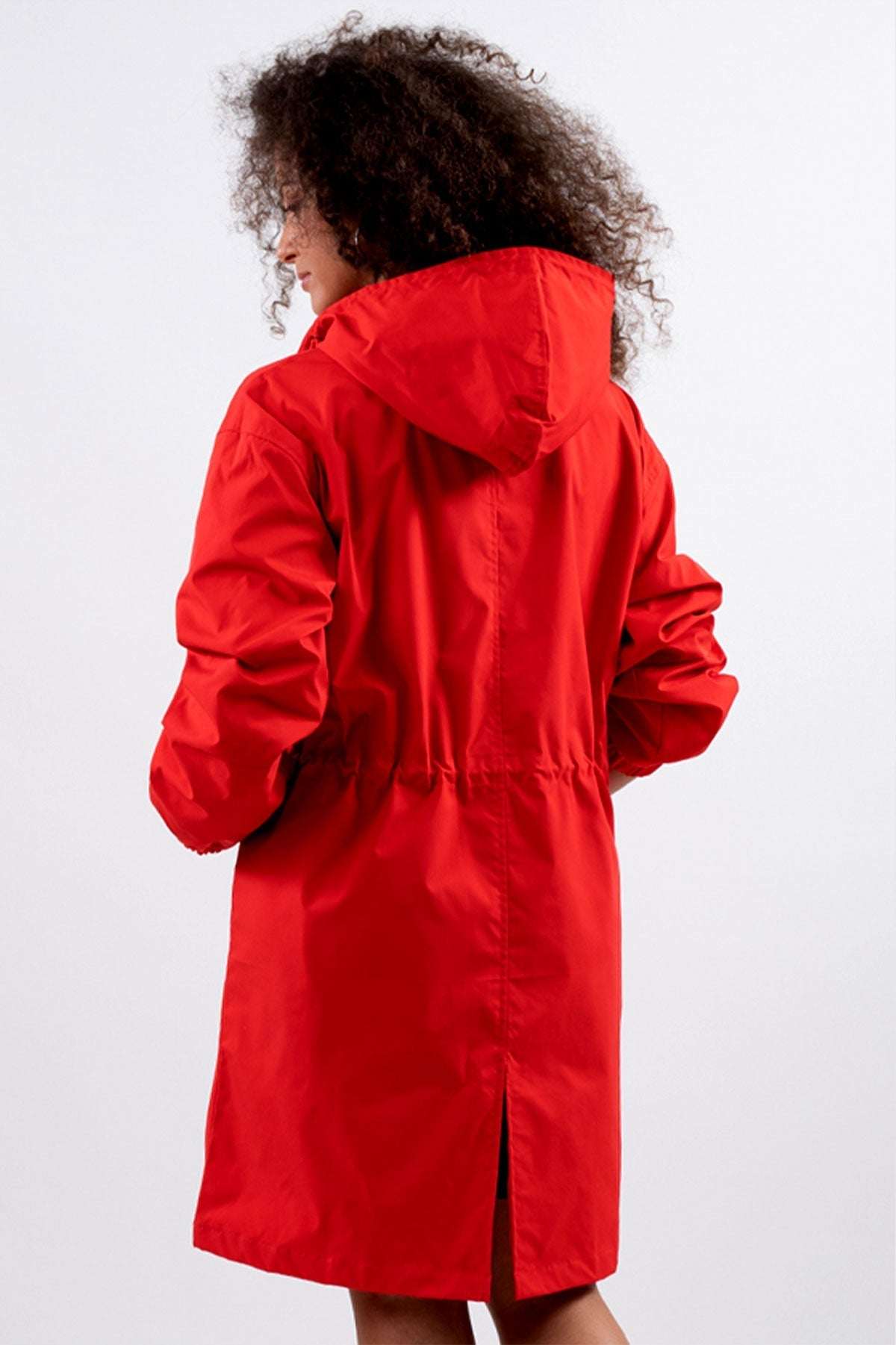 Red water-resistant oversized windbreaker rain jacket with hood and long back slit.