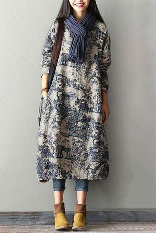 Woman wearing loose fit Japanese porcelain print midi dress with 3/4 sleeves and oversized pockets, styled with scarf and ankle boots