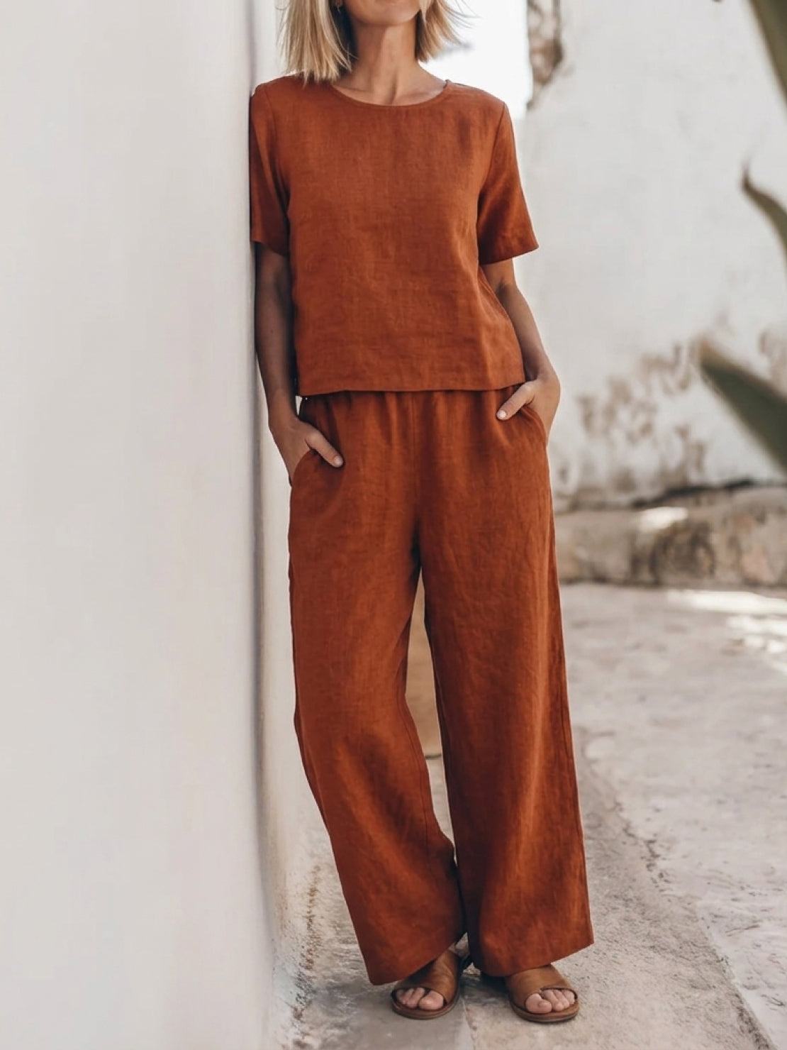 woman wearing loose fit co-ord set with soft-tailored top and wide-leg bottoms in light cotton fabric