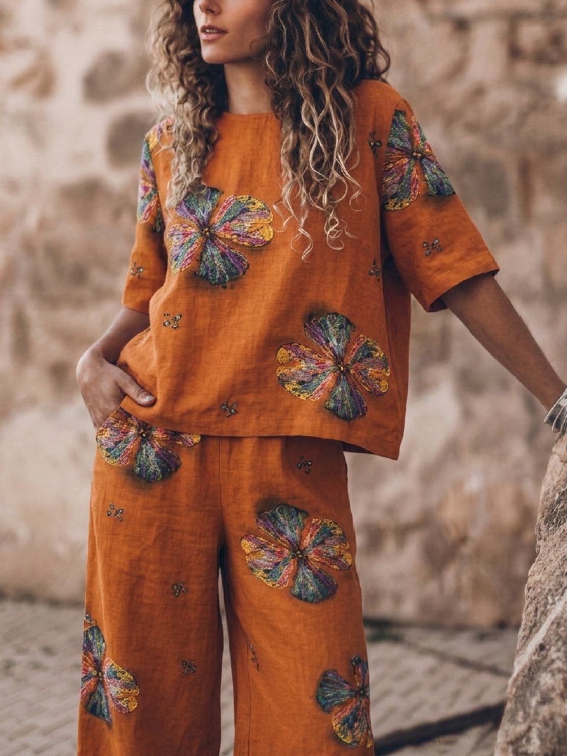woman wearing loose fit co-ord set with soft-tailored top and wide-leg cotton trousers