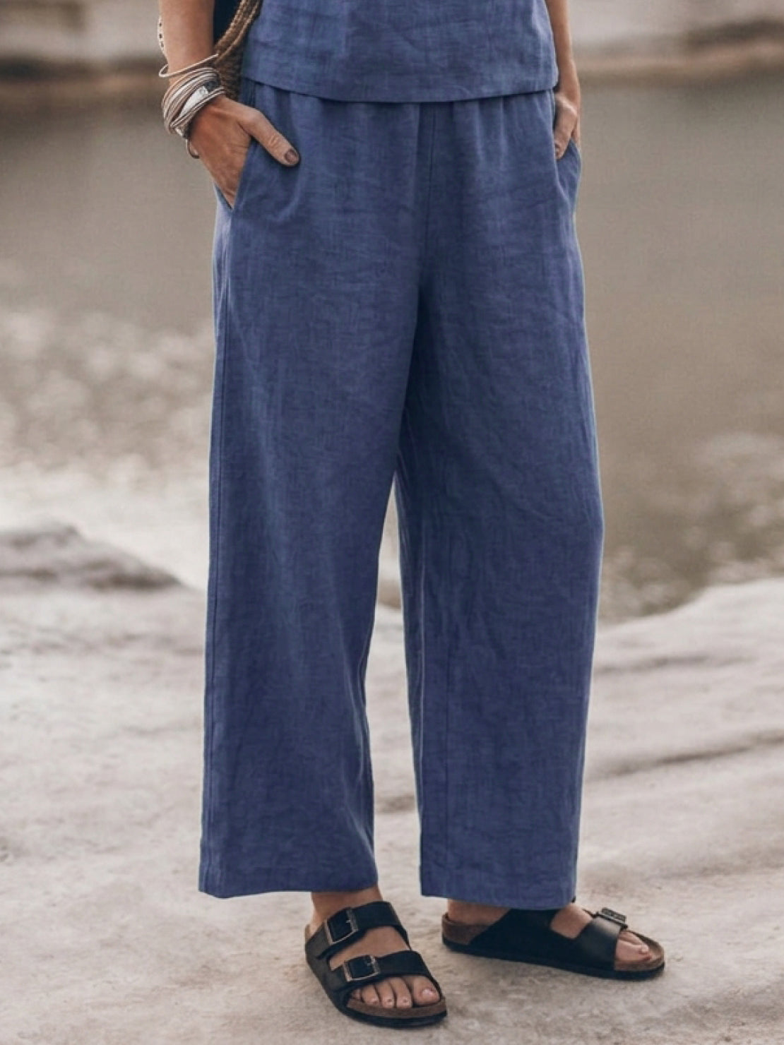 woman wearing loose fit co-ord set with soft-tailored top and wide-leg cotton trousers in light color