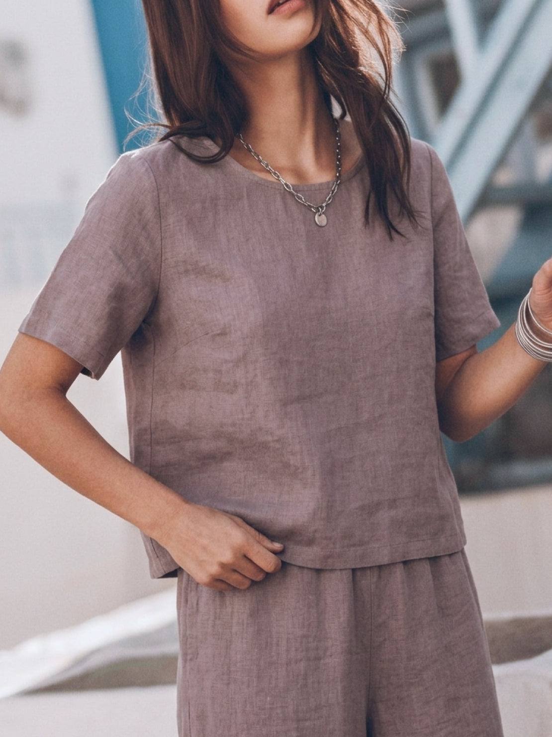 Woman wearing a soft cotton loose fit co-ord set with a relaxed top and wide-leg trousers