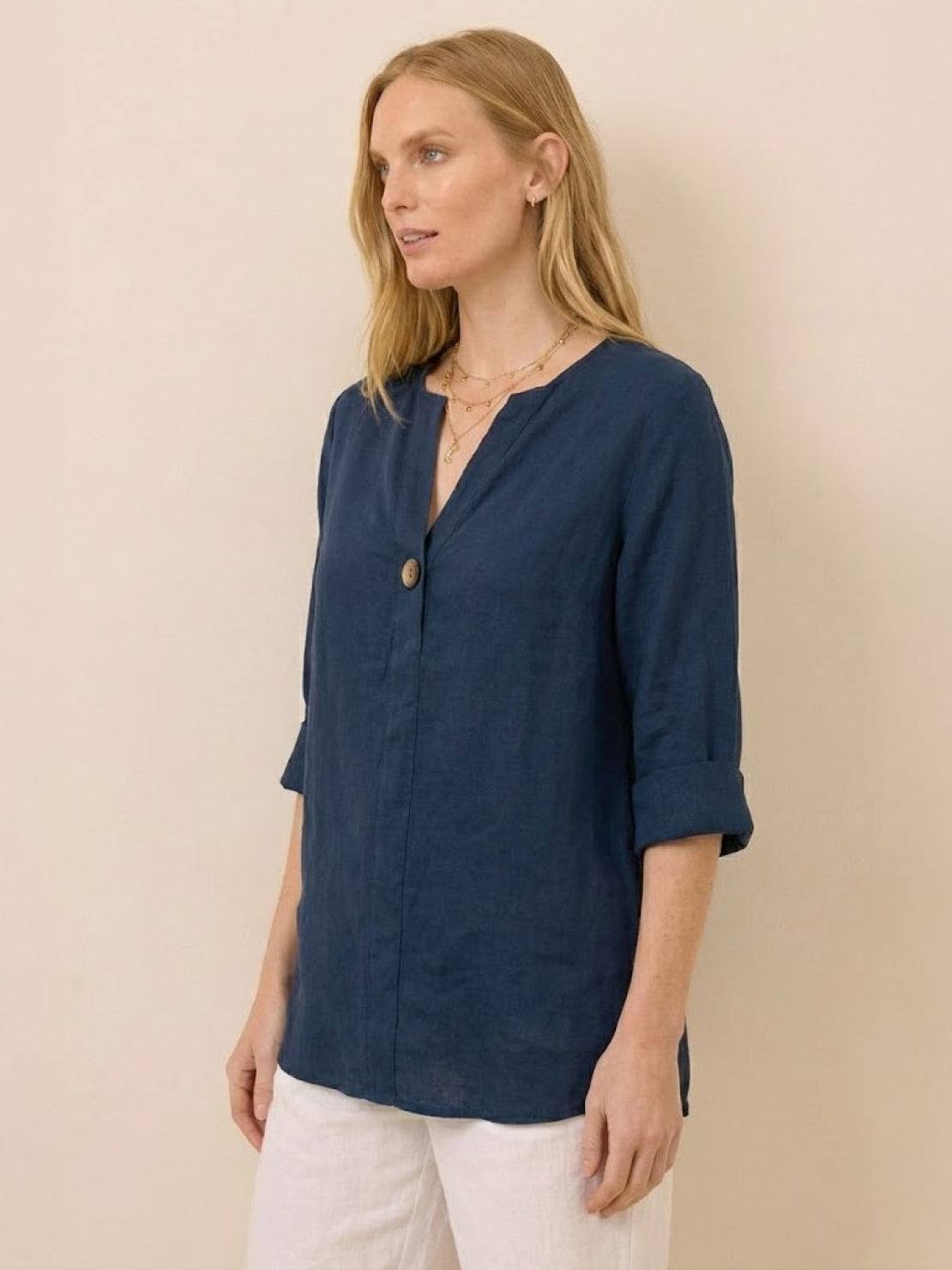 Woman wearing navy pure linen age-defying button detail shirt with three-quarter sleeves.
