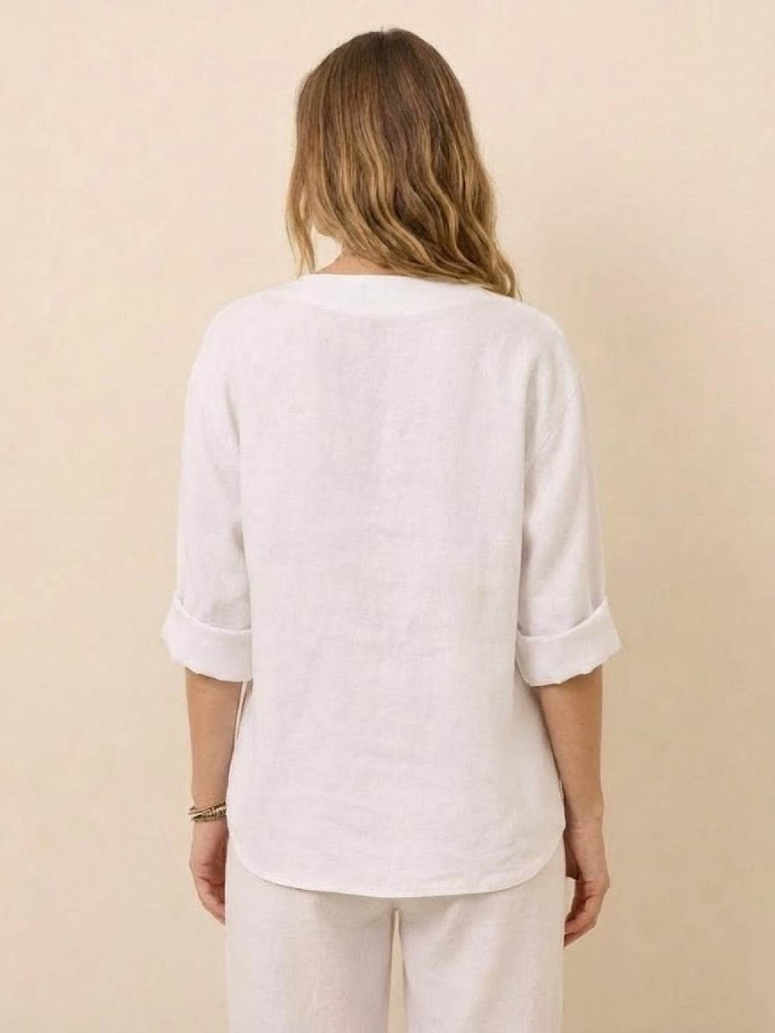 Back view of woman wearing a white Pure Linen Age-Defying Button Detail Shirt with rolled sleeves and relaxed fit.
