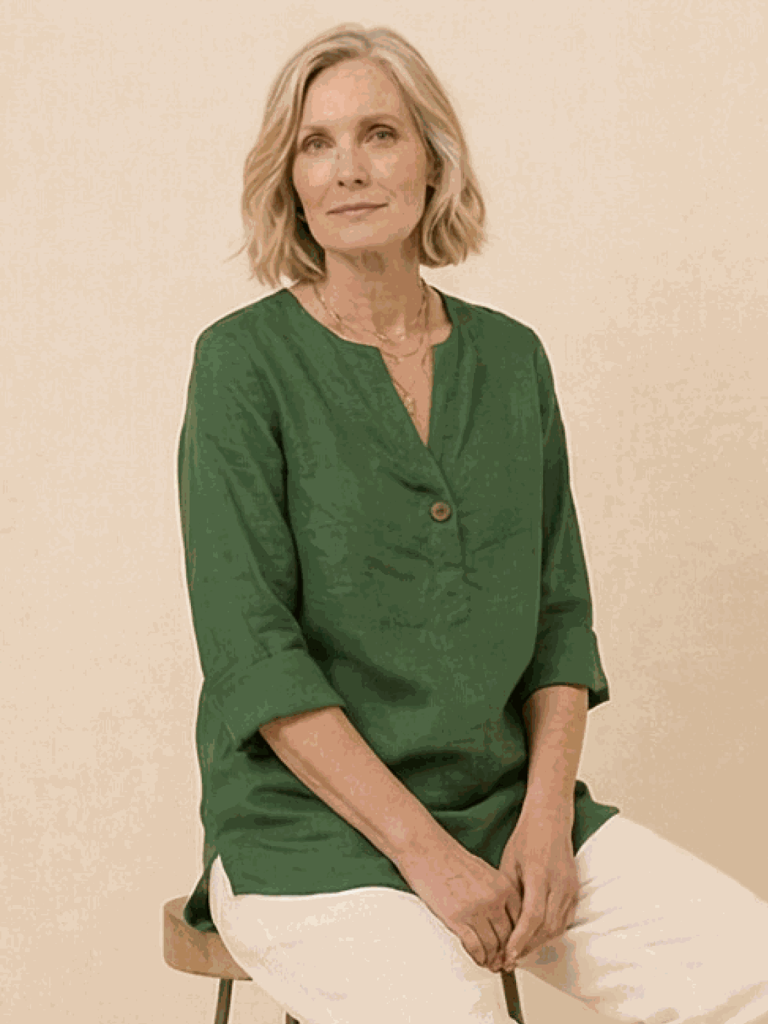 woman wearing pure linen age-defying button detail shirt in white with rolled-up sleeves