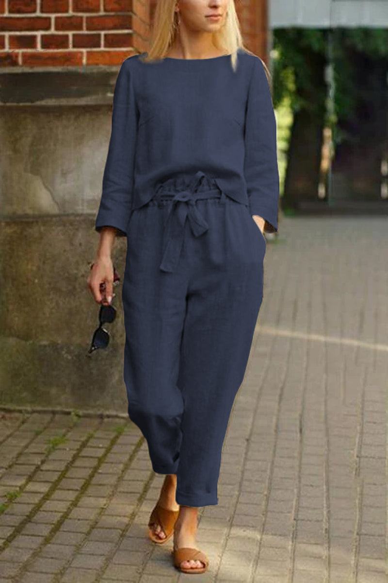 woman wearing navy blue cotton-linen monochrome capsule relaxed longline top and wide-leg pants set walking outdoors
