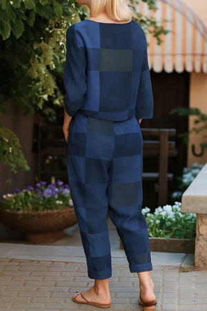 Woman wearing blue cotton-linen monochrome capsule outfit with relaxed longline top and wide-leg pants standing outdoors