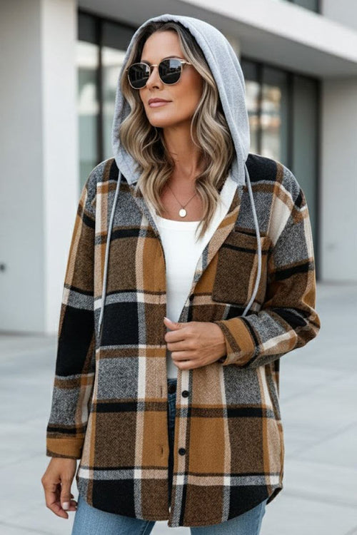 Highland Plaid Shacket with hood, plaid pattern, and button-front closure, styled on a woman outdoors