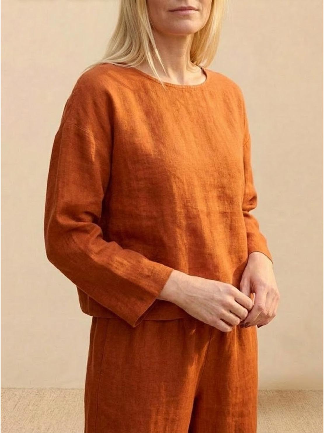 woman wearing loose solid color two-piece set with round neck pullover and wide-leg pants in neutral tones