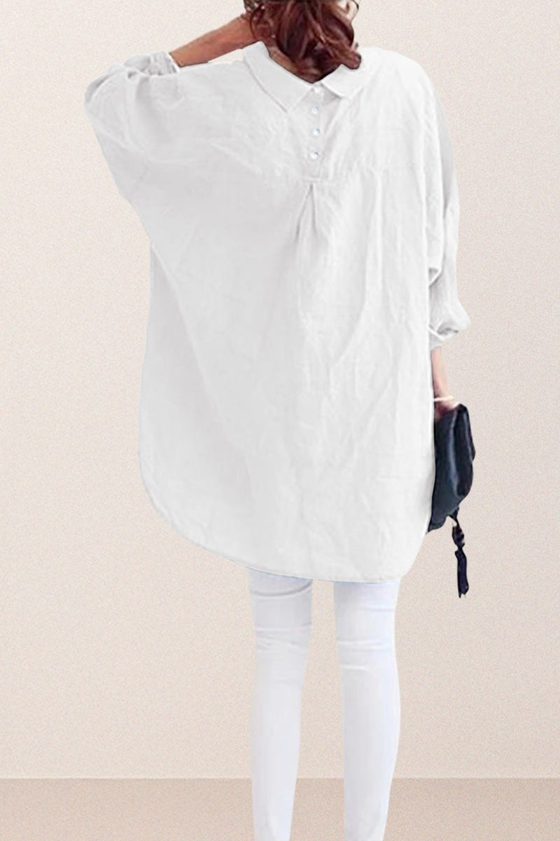 Back view of a white oversized linen shirt with relaxed sleeves worn over white pants