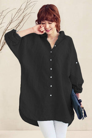 Woman wearing oversized black linen shirt with relaxed fit and button details