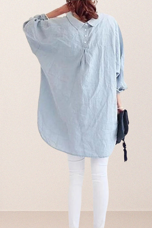 Back view of oversized linen shirt in light blue with relaxed fit and button details