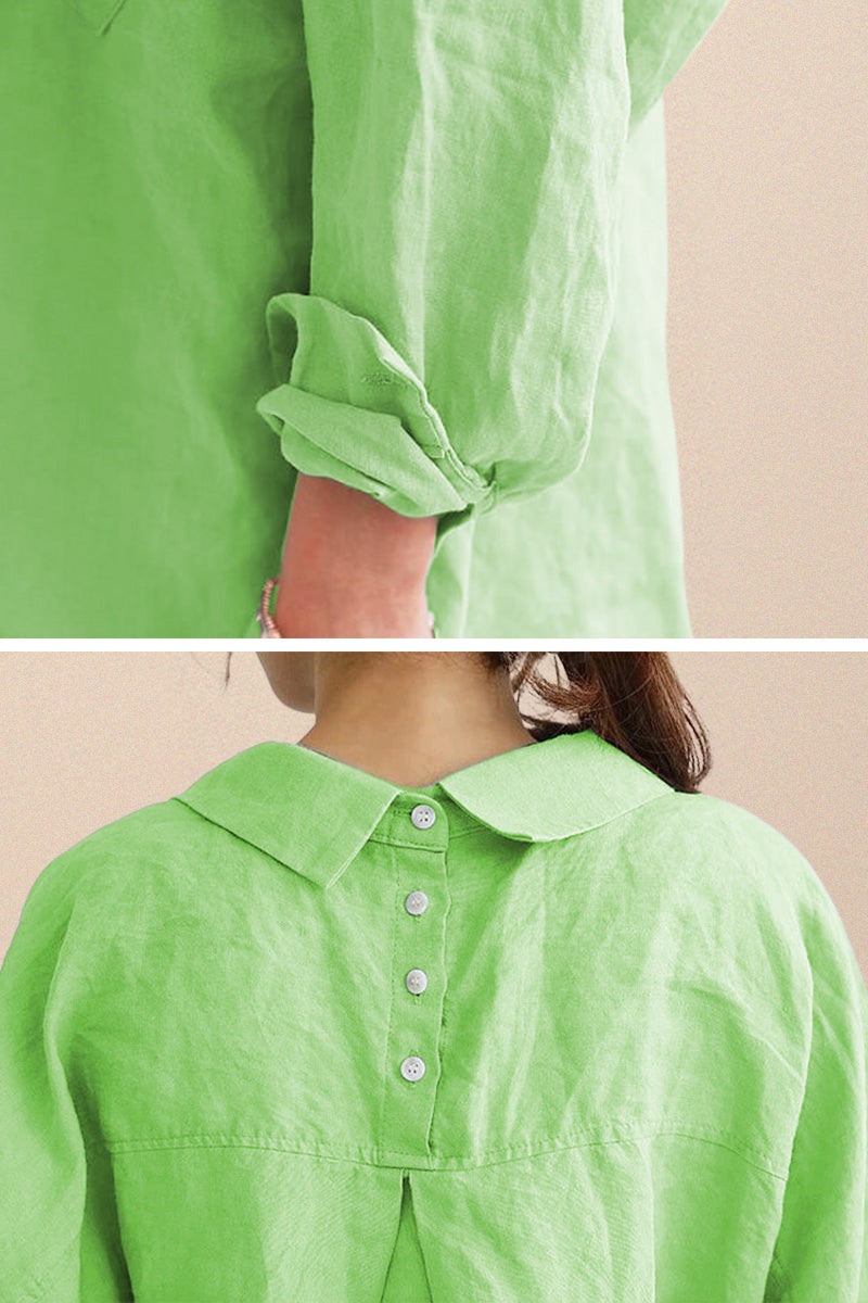 Close-up of a bright green oversized linen shirt with rolled sleeves and button details on the back yoke