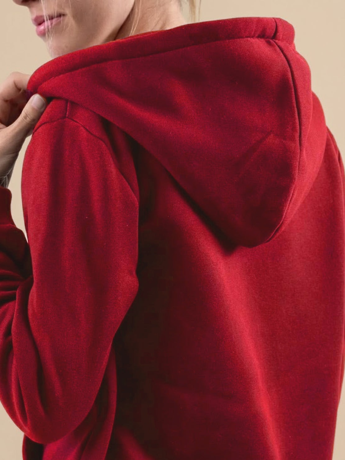 Close-up of a red oversized long zip sweatshirt hoodie with fleece lining and hood.