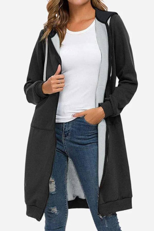 Black oversized long zip sweatshirt hoodie with fleece lining and drawstring hood worn over casual outfit