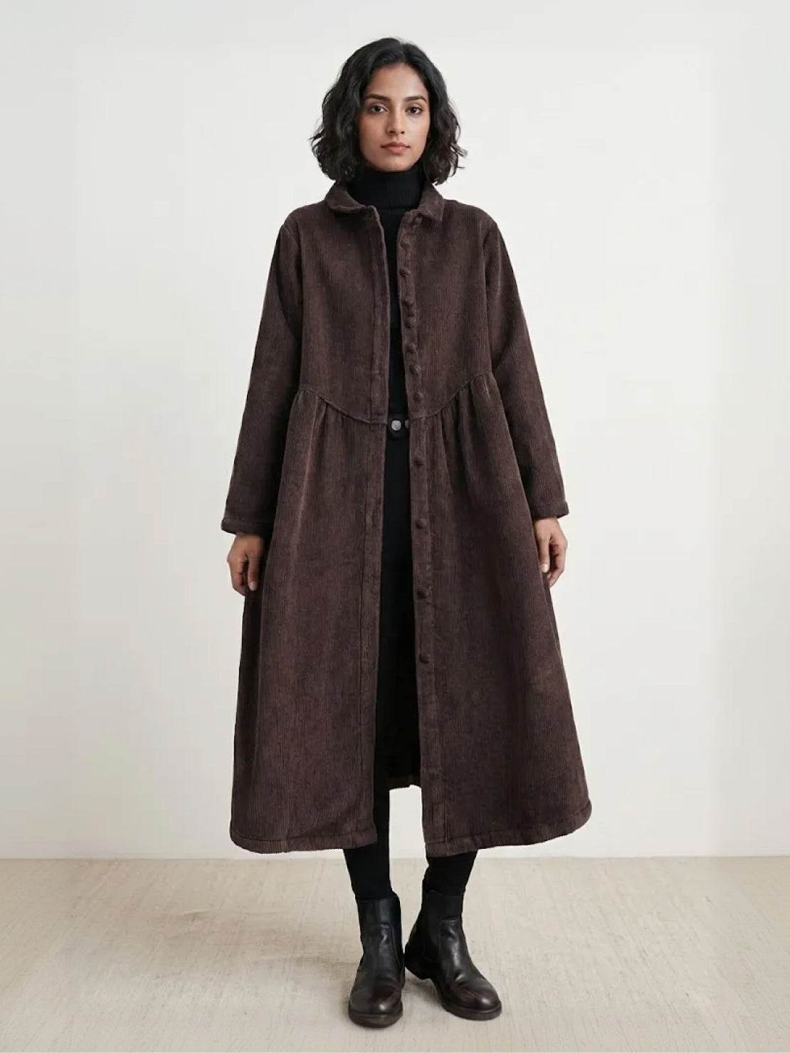 Oversized vintage corduroy coat in warm earth tones with thick texture and deep pockets for winter layering