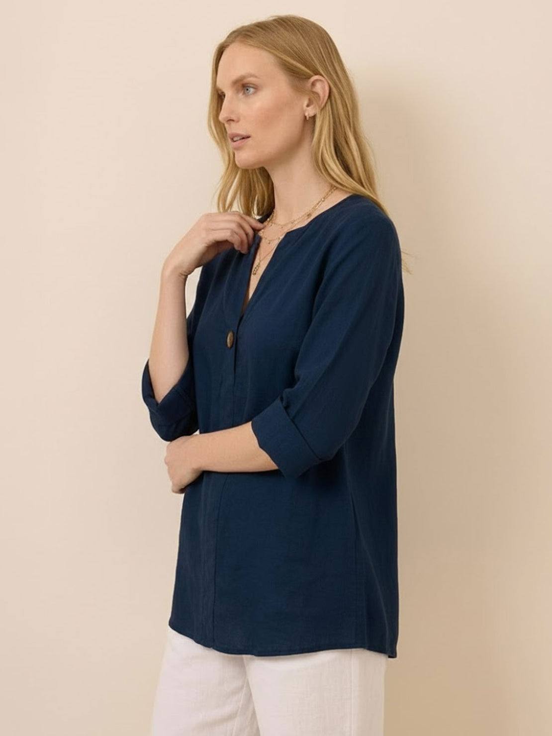 Woman wearing a pure linen age-defying shirt with button details, showcasing breathable and elegant summer fashion