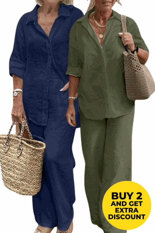 Two women wearing relaxed shirt and trousers two-piece sets in navy blue and olive green, carrying woven handbags, showcasing casual comfort and style.