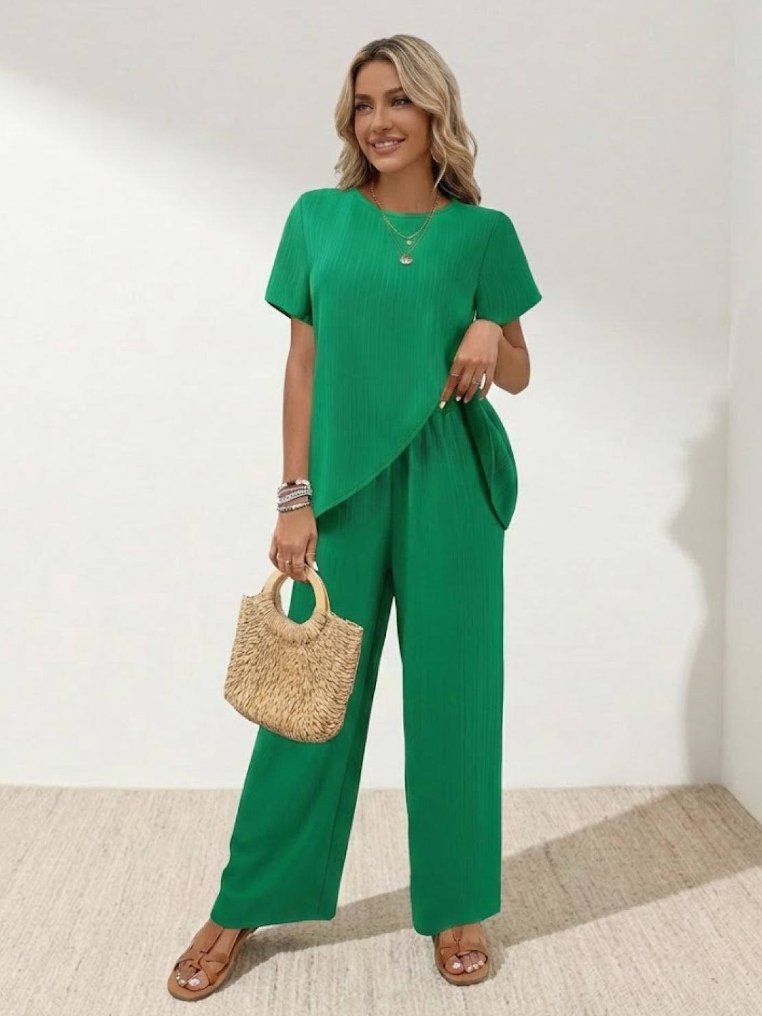 Woman wearing textured elegance two-piece set with asymmetrical top and wide-leg pants