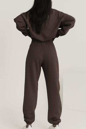 Back view of woman wearing brown cotton blend tracksuit with elastic waistband and cuffs