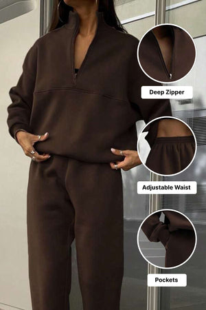 Brown cotton blend tracksuit with deep zipper, adjustable waist, and pockets for tailored comfort and style.