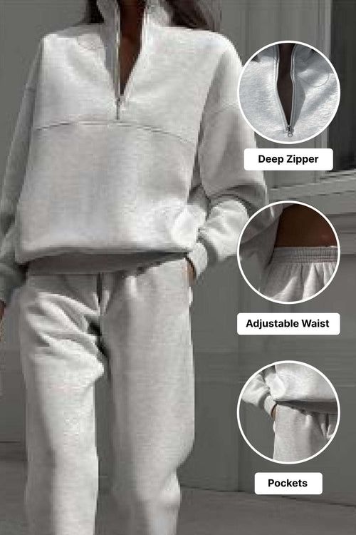 Woman wearing a light gray cotton blend tracksuit with deep zipper, adjustable waist, and pockets