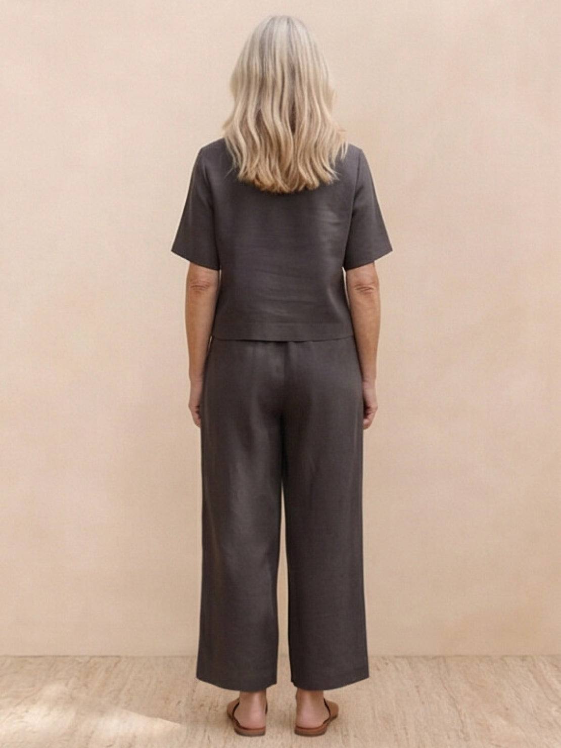 Woman wearing a loose fit co-ord set with soft-tailored top and wide-leg bottoms in a relaxed style