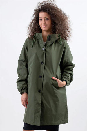 Woman wearing oversized olive green Rain Couture Windbreaker jacket with hood and pockets