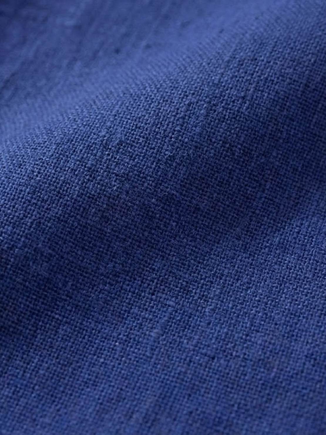 Close-up of blue cotton fabric texture for Timeless Class cotton dress