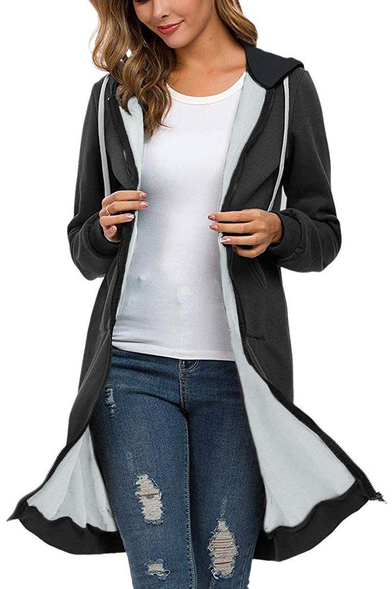 Oversized long zip sweatshirt hoodie in black with fleece lining, drawstring hood, and large front pockets worn over white top and jeans