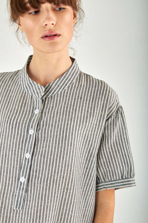 Close-up of striped gauze shirt dress with stand-up collar and button fastening in linen cotton blend fabric