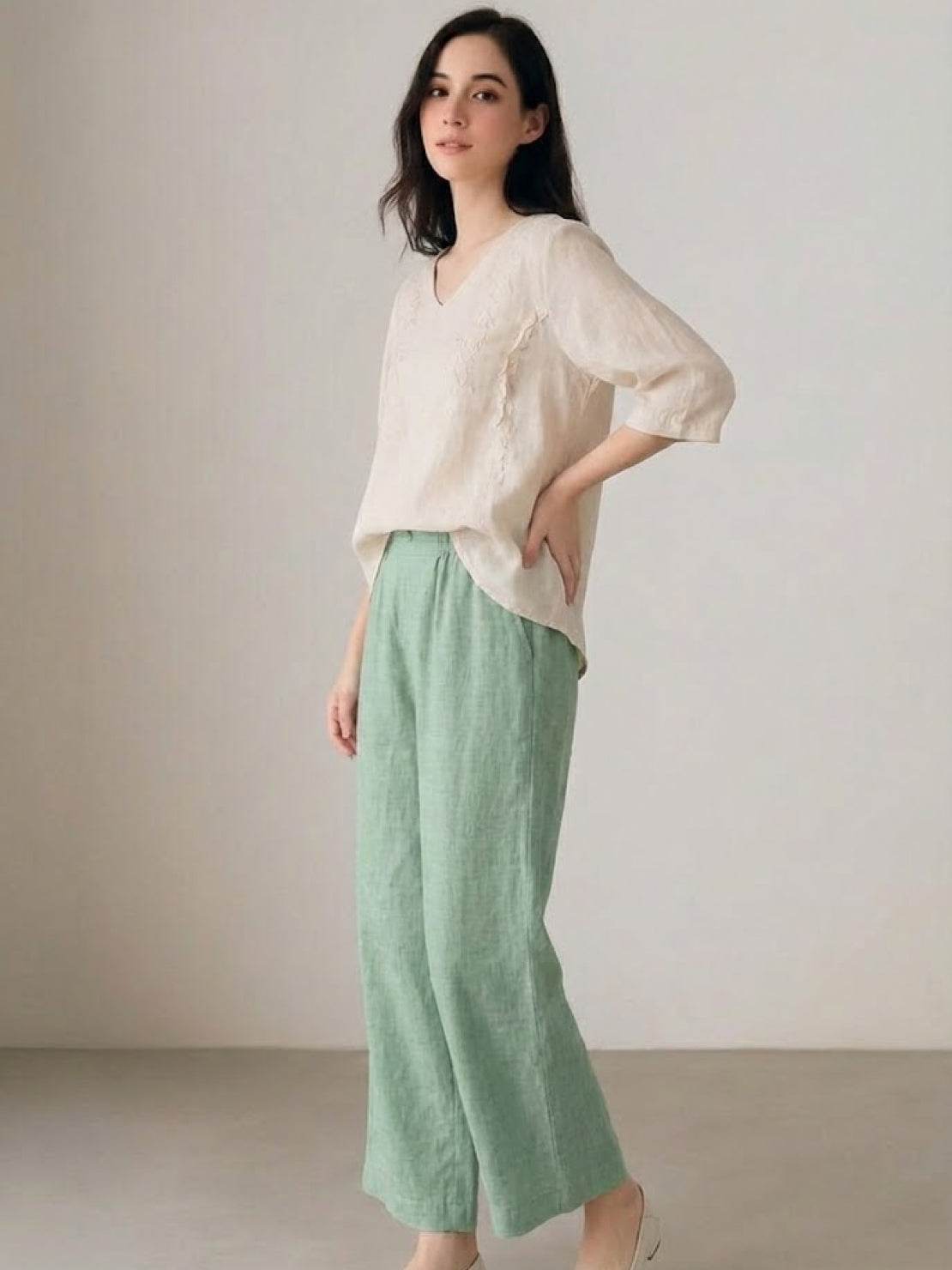 Woman wearing 100% cotton linen blend golden hour set with embroidered top and wide-leg trousers
