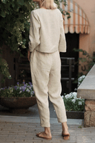 Woman wearing beige 100% cotton linen monochrome two-piece set outdoors