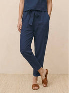 Woman wearing relaxed 100% cotton linen set with short-sleeve top and straight-leg pants.